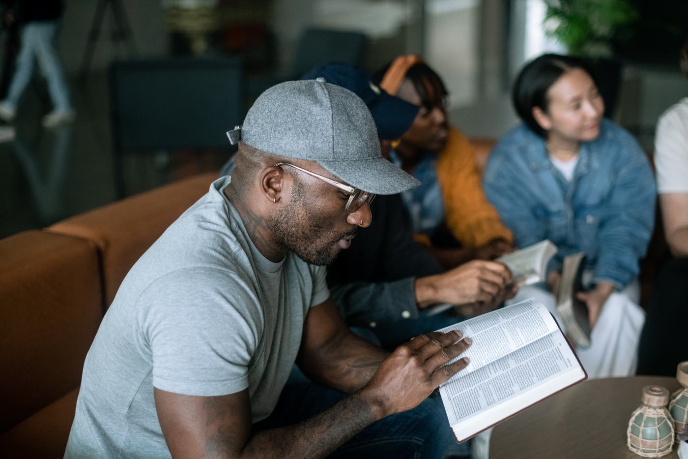 A group member reading his Bible while the group listens